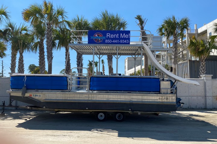 a truck is parked in front of a blue bench